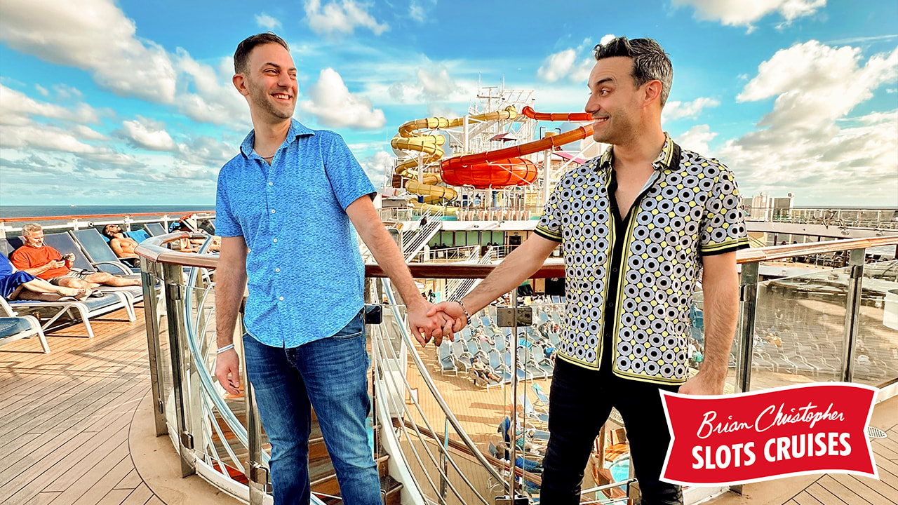 Brian and Marco holding hands on the top deck of a Carnival ship